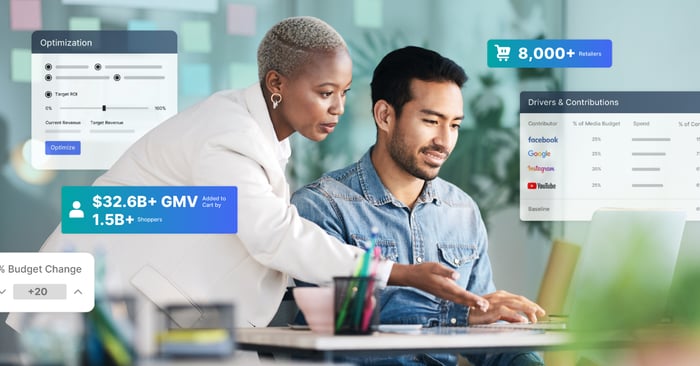 Marketing team analyzing real-time media measurement data and performance insights on a laptop